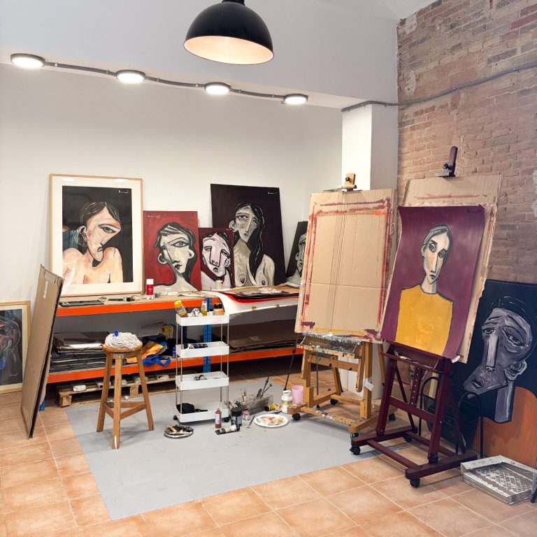 Reformas en locales comerciales Taller de arte con pinturas en las paredes, caballetes y materiales de trabajo.